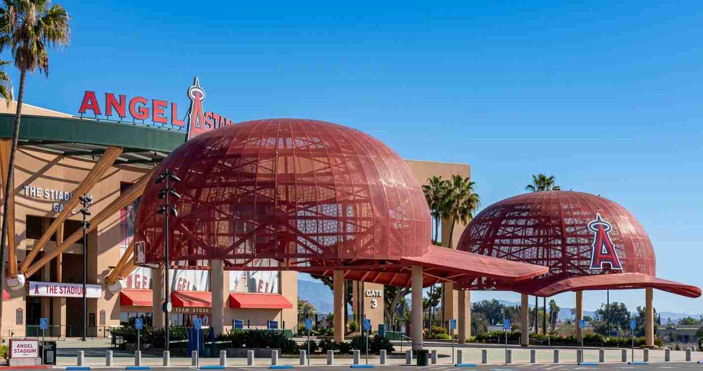 Exterior view of Angel Stadium with red geodesic dome structures and clear blue sky behind it, Anaheim, California