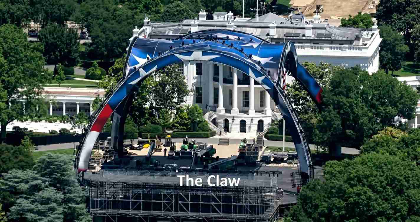 Large blue-and-red arched stage structure labeled 'The Claw' set up in front of a white neoclassical building.