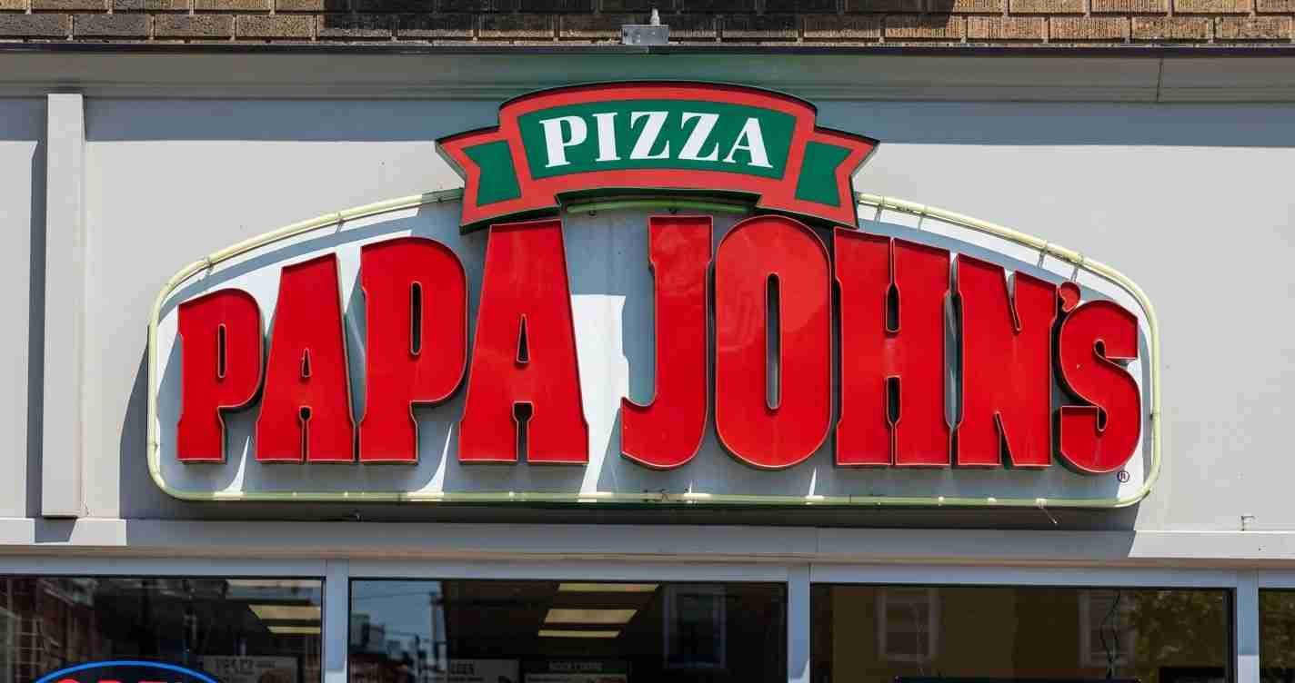 Papa John's pizza storefront sign with large red lettering and green banner saying PIZZA on top