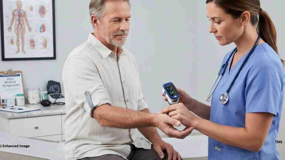 Nurse in blue scrubs checks an older man's blood pressure with a digital monitor in a clinic.
